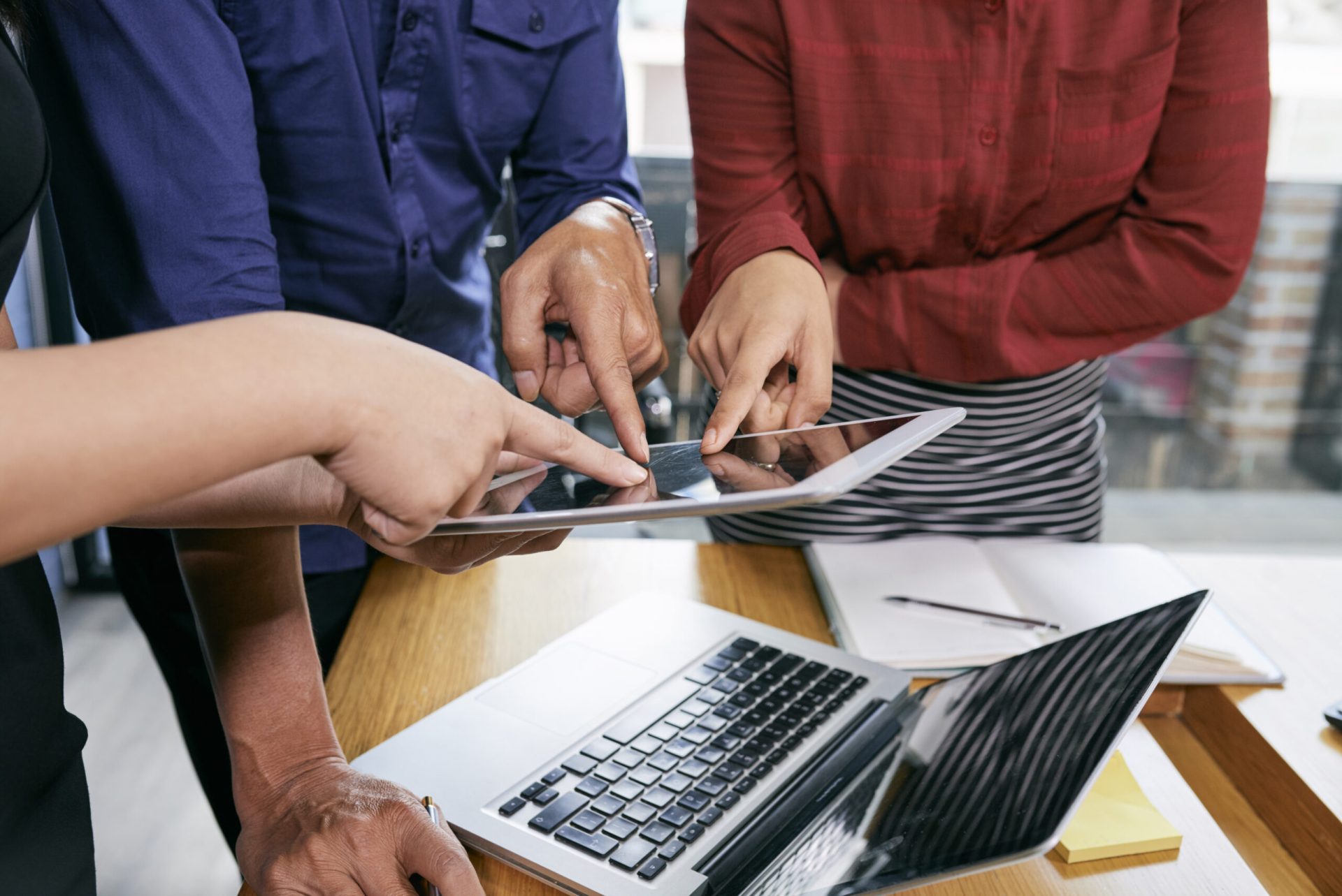 Business team pointing at document on digital tablet